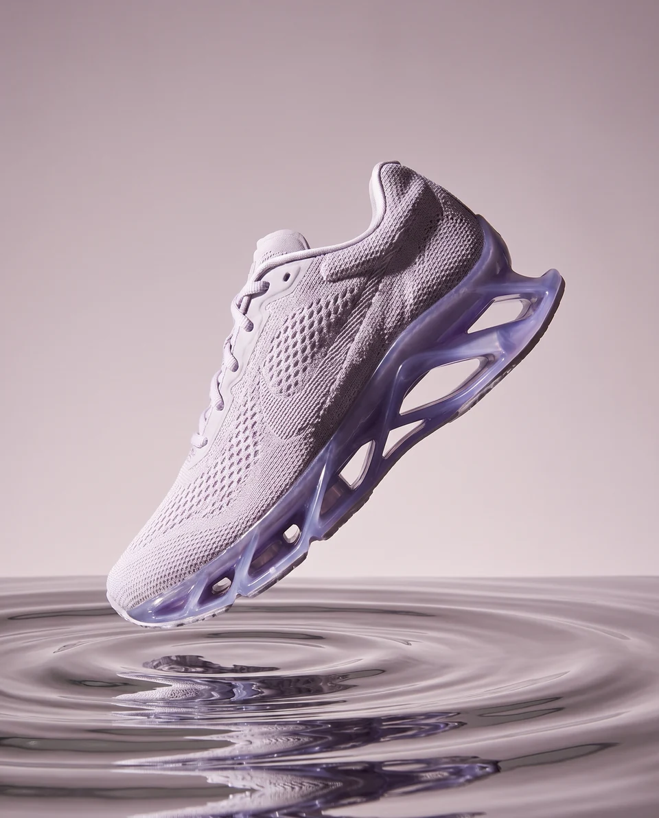 Violet running shoe above liquid chrome